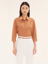 a lady in caramel cotton shirt